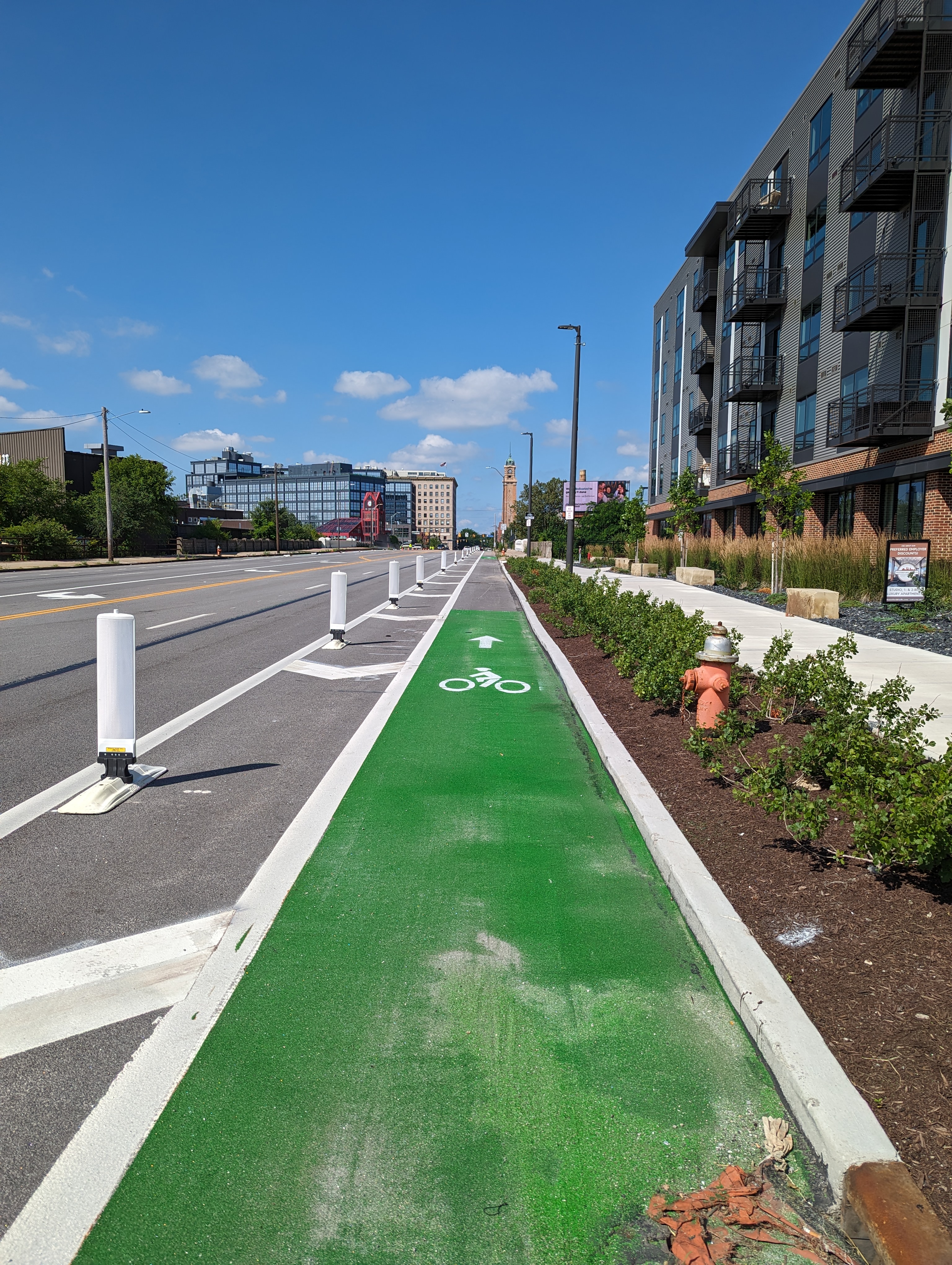 A separated bike lane on Lorain Avenue with green paint