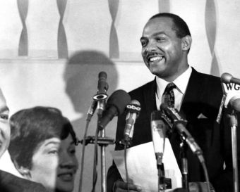 carl stokes speaking at microphone