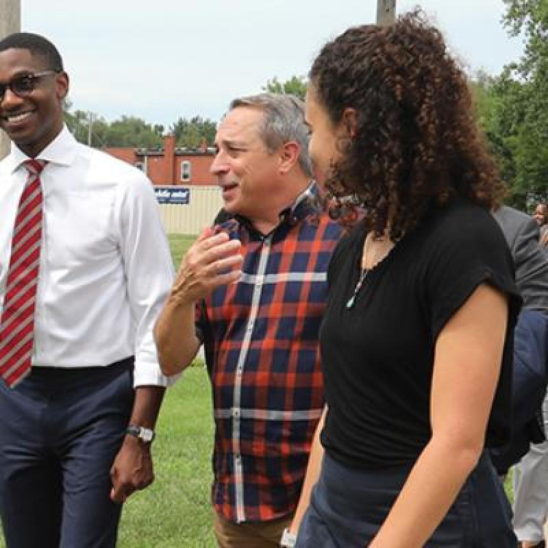 mayor bibb walking next to a bunch of individuals