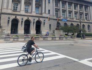 person on bike in front of city hall